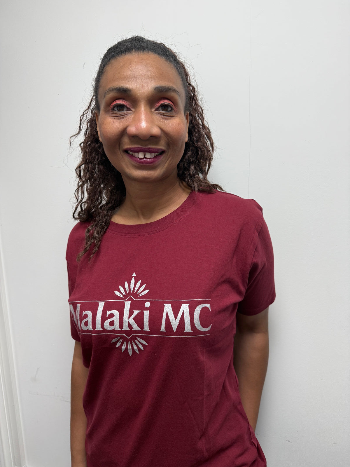 Malaki MC Women's Burgundy T-Shirt - White Logo, indoor close-up shot