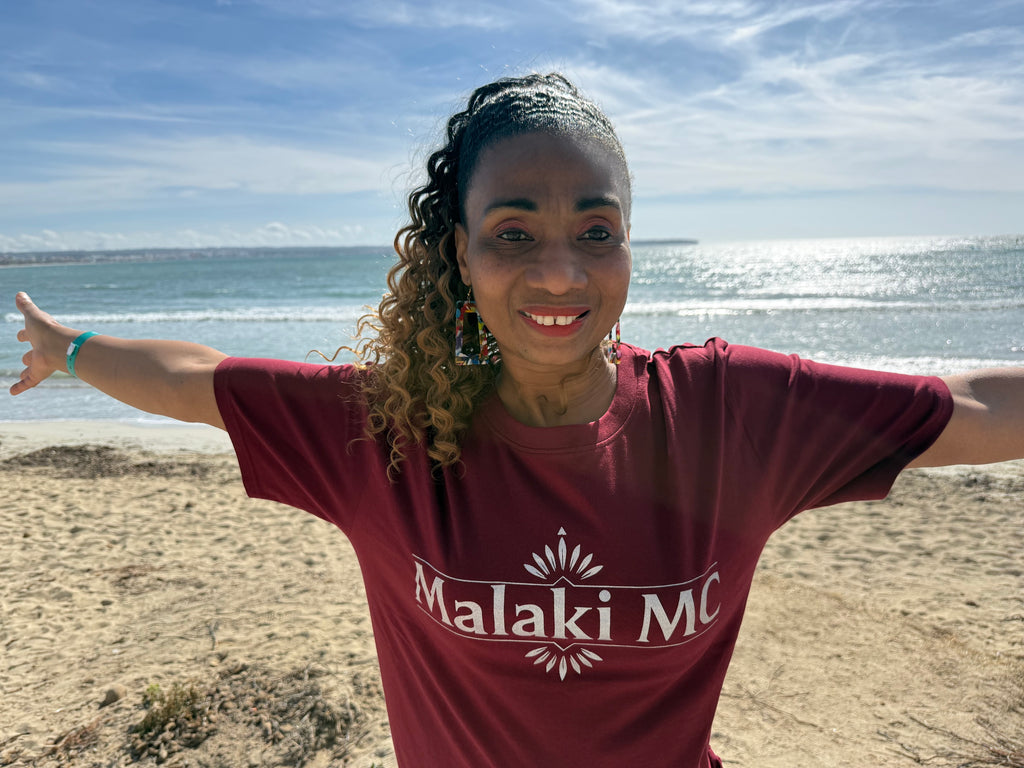 Malaki MC Women's Burgundy T-Shirt - White Logo, beach close-up shot