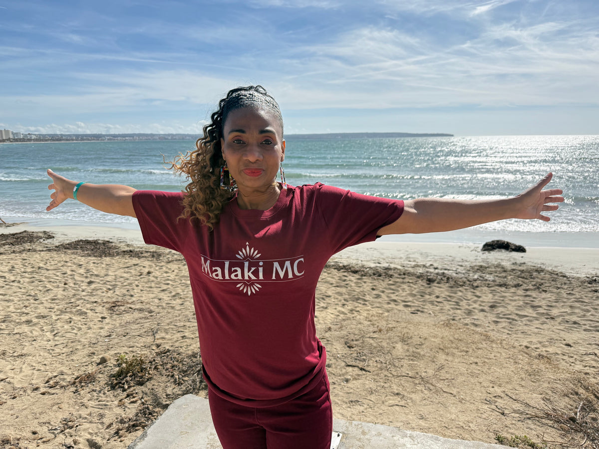 Malaki MC Women's Burgundy T-Shirt - White Logo, beach editorial shot