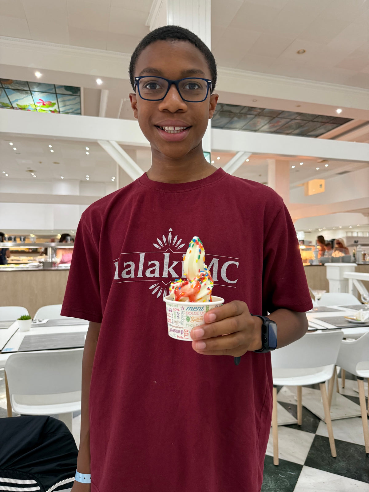 Malaki MC Burgundy T-Shirt lifestyle photo with Malaki holding ice cream