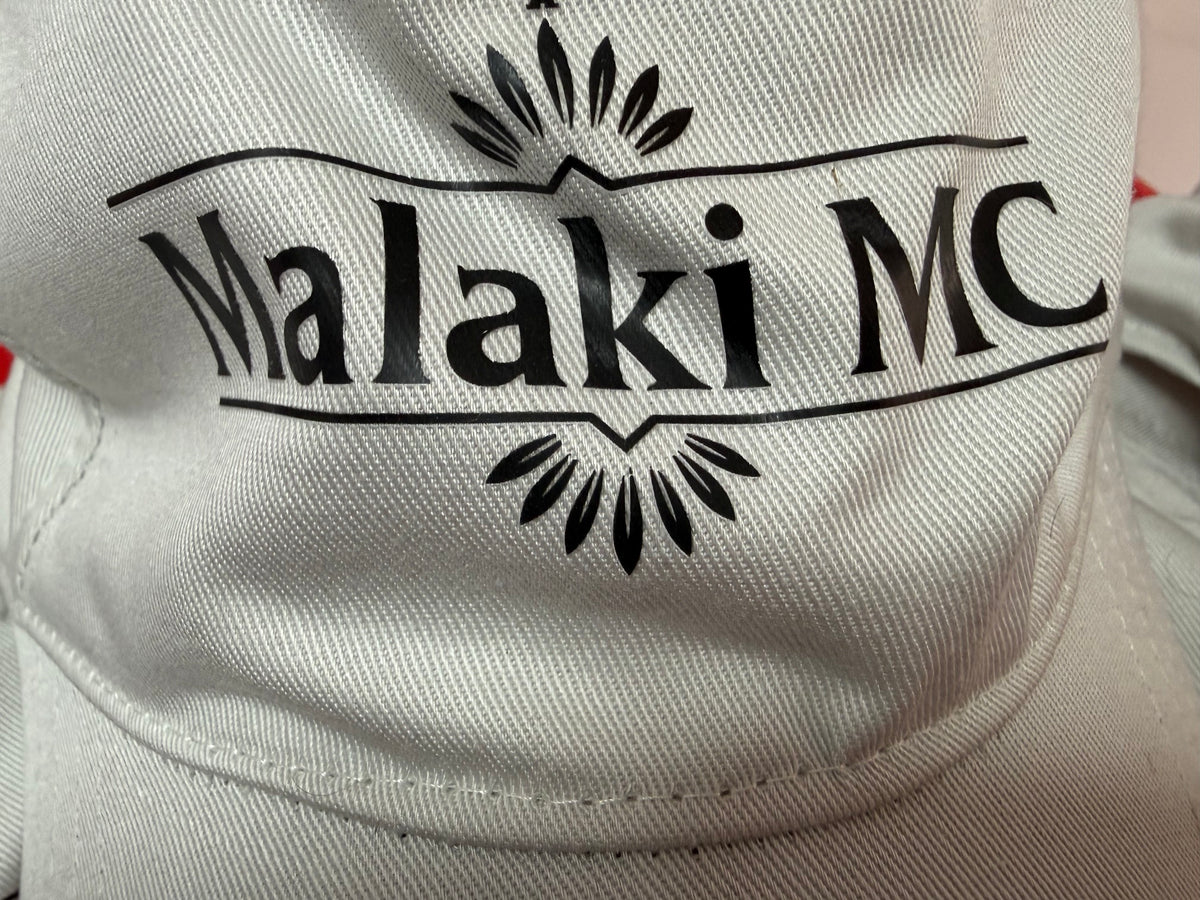 Malaki MC logo close-up on white cap - sunburst branding detail