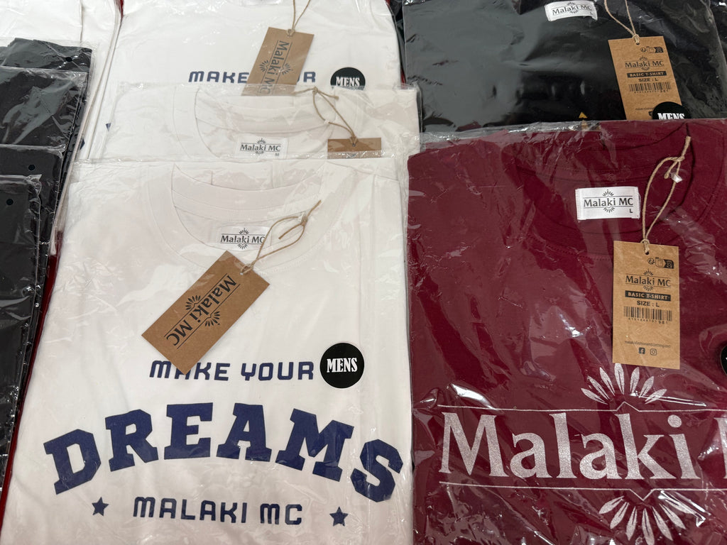 Malaki MC white Make Your Dreams and burgundy t-shirts in branded packaging