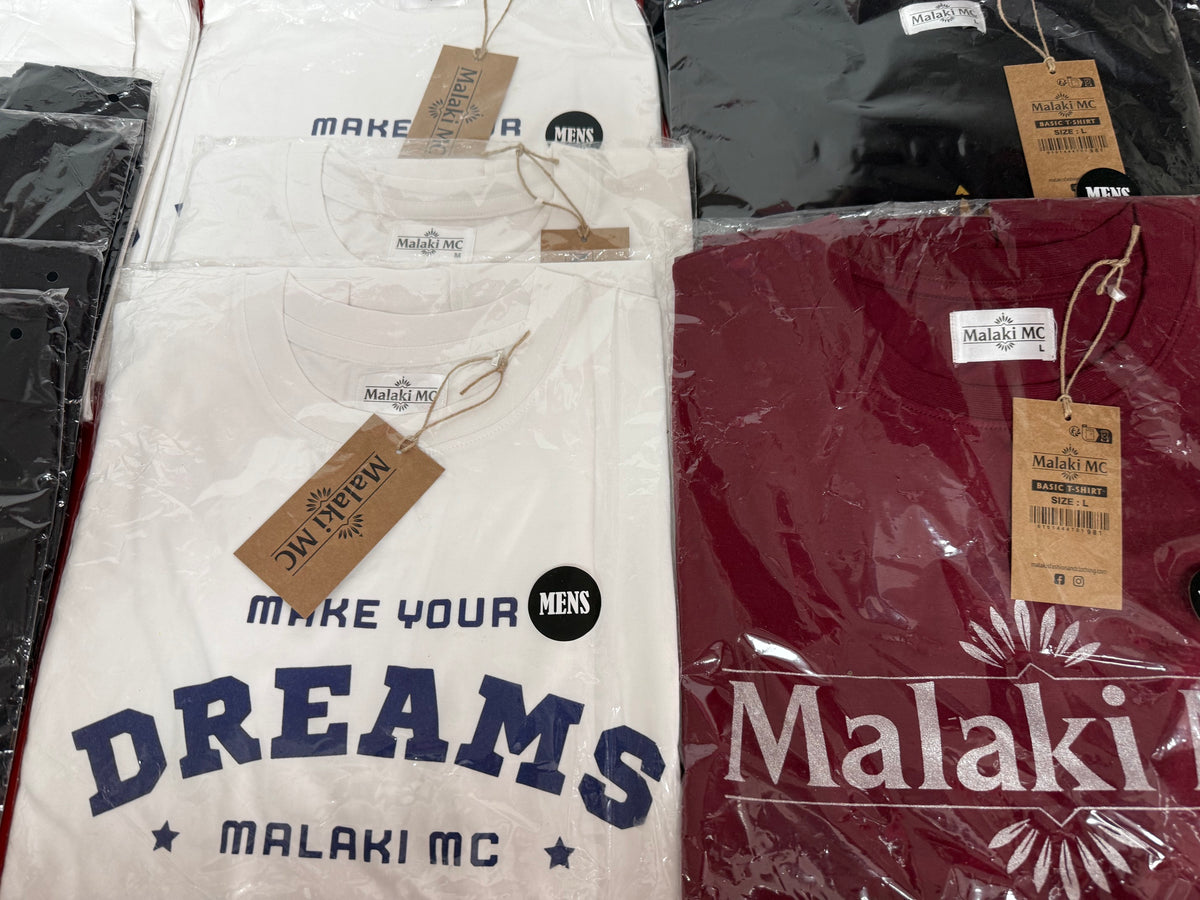 Malaki MC white Make Your Dreams and burgundy t-shirts in branded packaging